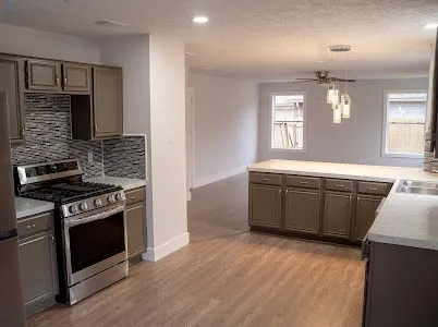 a kitchen that has a sink and a stove