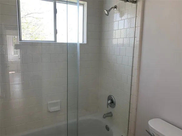 a bathroom with a bathtub and shower