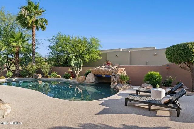 a view of a backyard with furniture and a garden