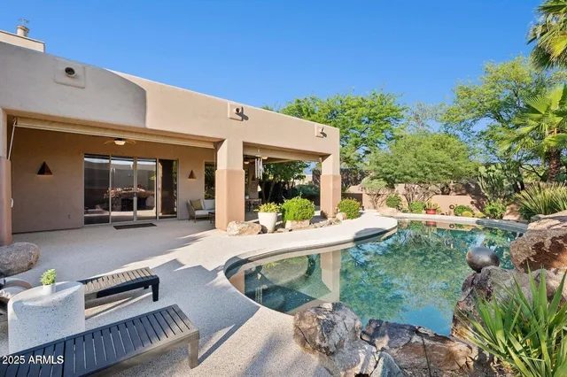 a view of a patio with table and chairs and potted plants