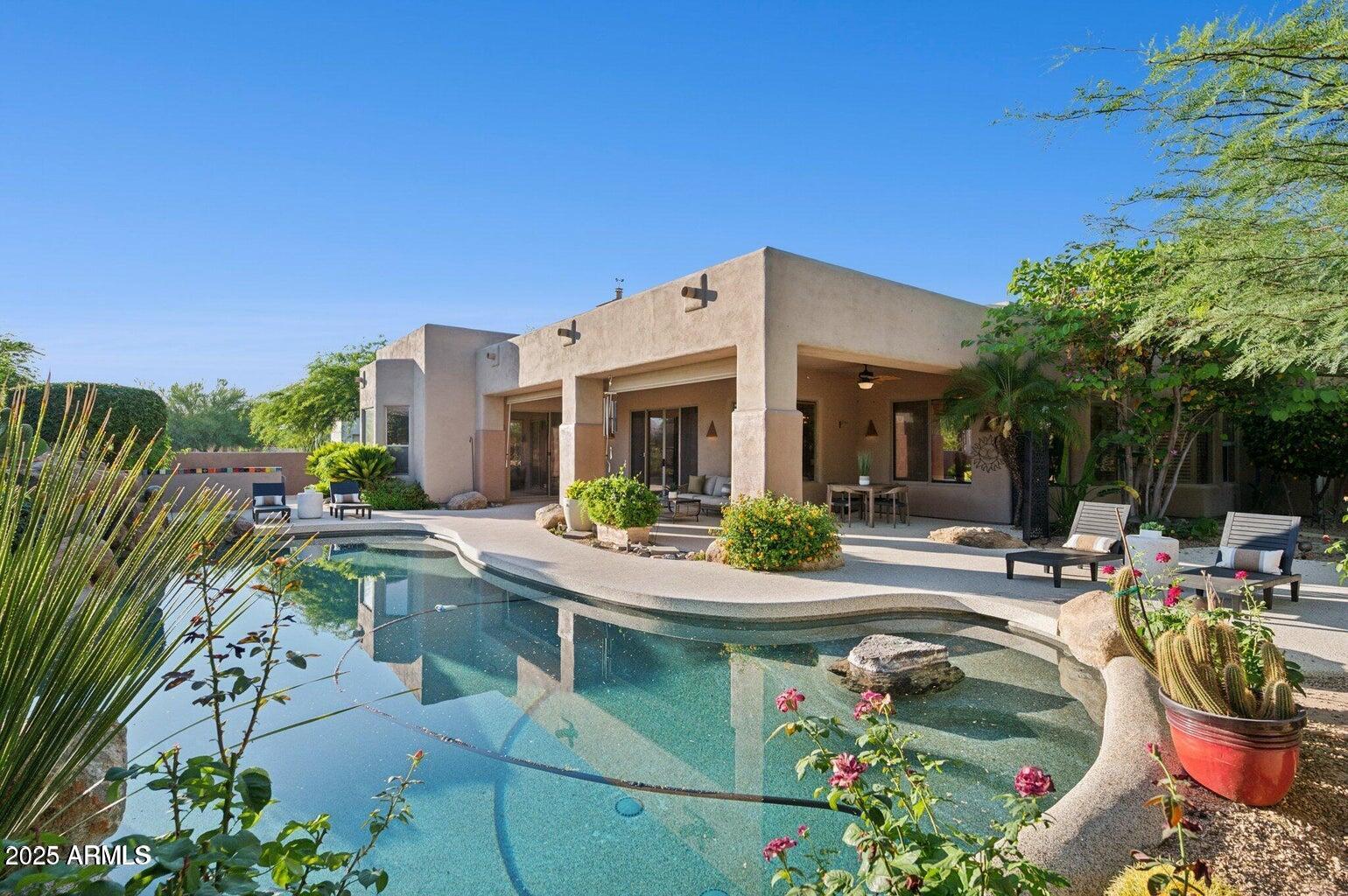 11299 East Greythorn Drive Scottsdale, AZ 85262 - Photo 2 of 13 a view of a house with swimming pool and sitting area