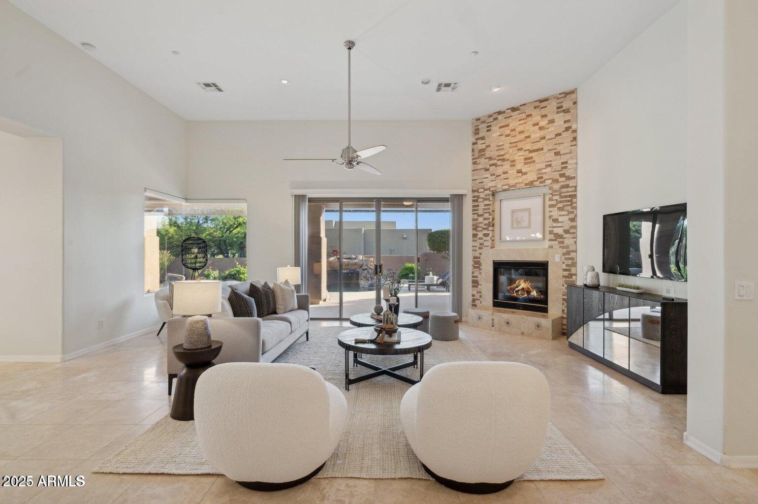 11299 East Greythorn Drive Scottsdale, AZ 85262 - Photo 3 of 13 a living room with fireplace furniture and a fireplace
