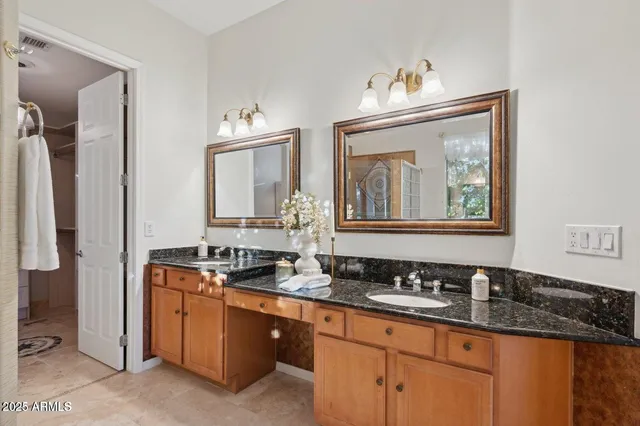 a bathroom with double sink and a mirror