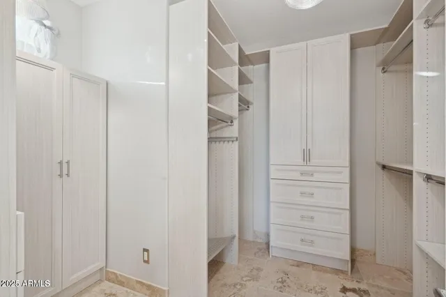 a view of walk in closet with white walls
