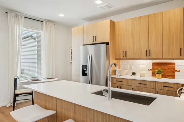 a kitchen with kitchen island a sink table and chairs