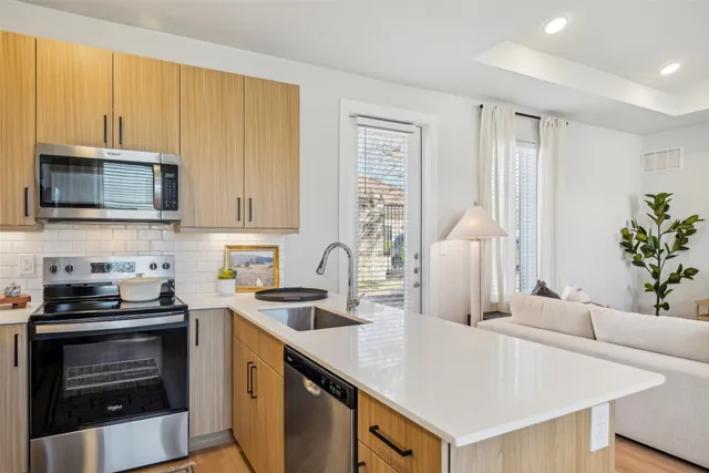 a kitchen with a sink a stove and cabinets