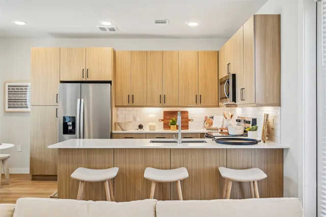 a kitchen with stainless steel appliances granite countertop a sink and a white cabinets