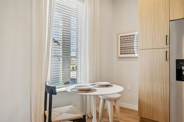 a view of a dining room with a table and chairs
