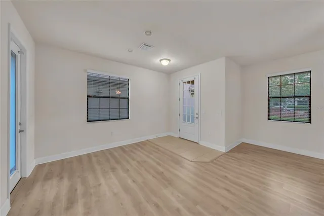 wooden floor in an empty room with a window