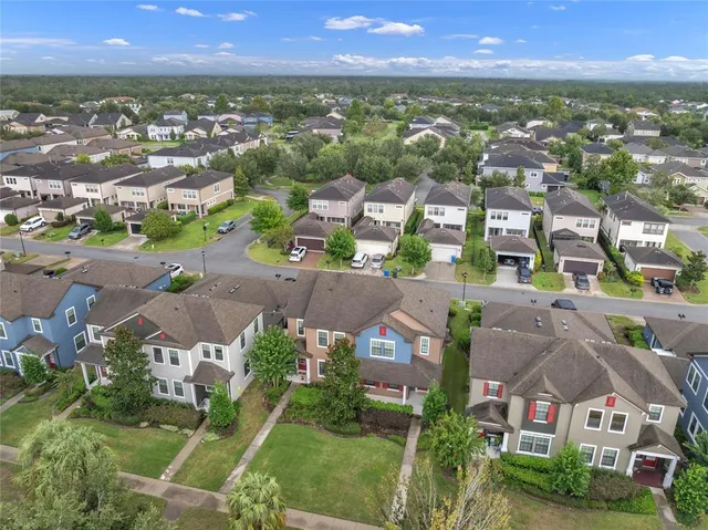 an aerial view of residential houses with outdoor space