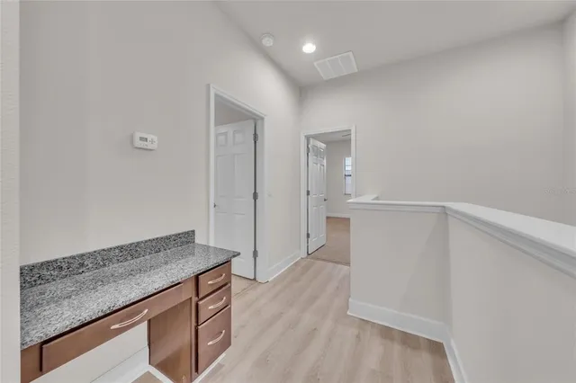 a view of kitchen island with wooden floor