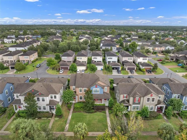 an aerial view of residential houses with outdoor space and ocean view