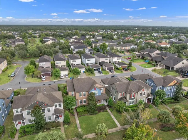 an aerial view of residential houses with outdoor space and river