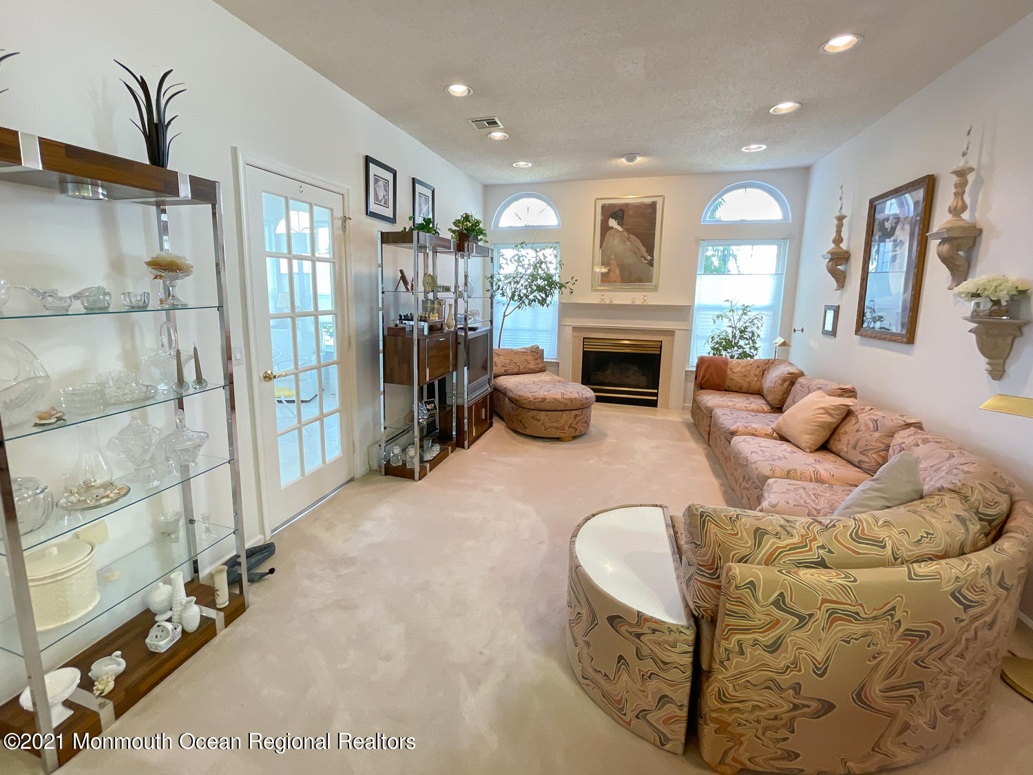 26 Symphony Avenue Bayville, NJ 08721 - Photo 11 of 40 a living room with furniture a fireplace and a chandelier