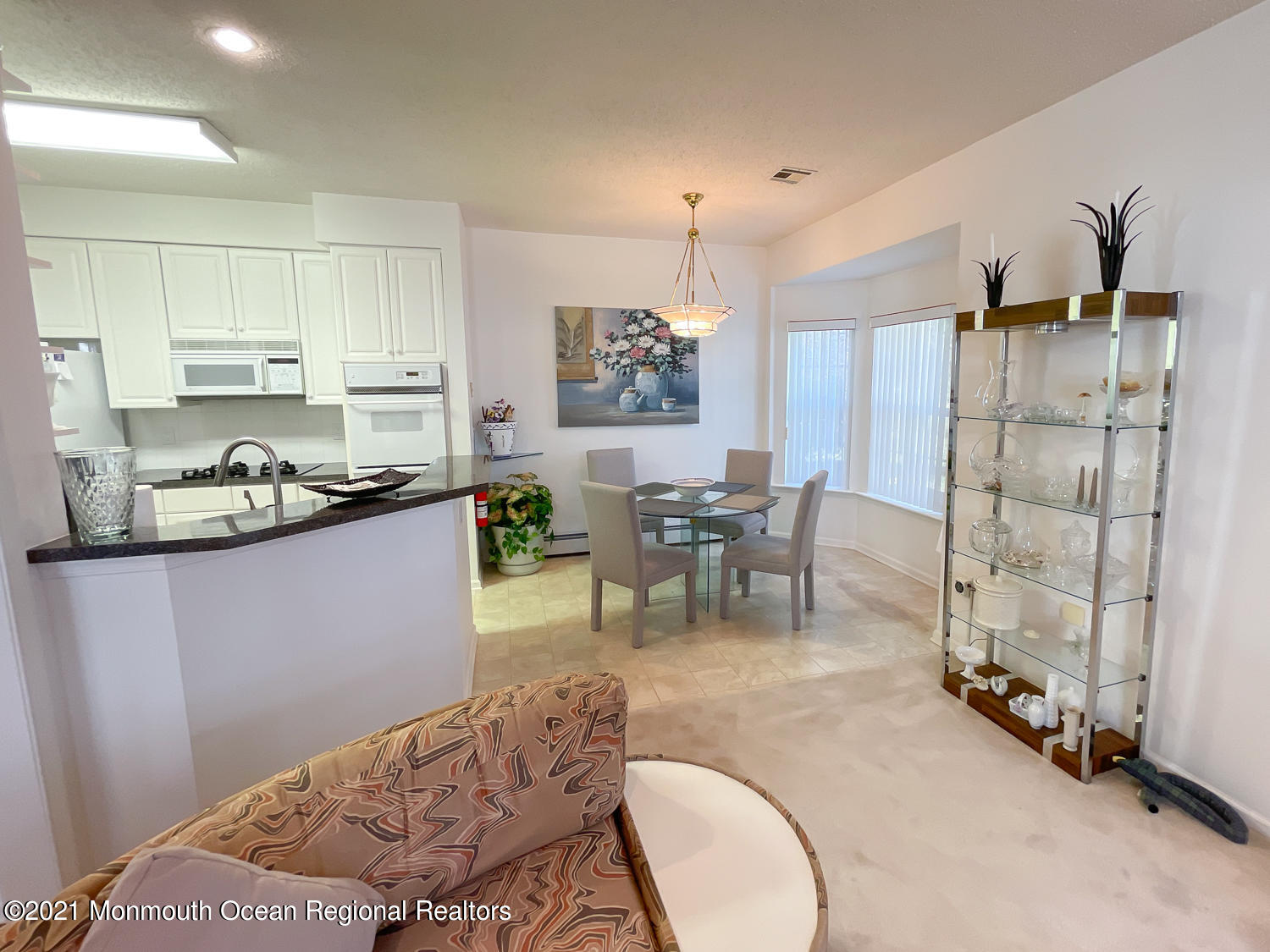 26 Symphony Avenue Bayville, NJ 08721 - Photo 13 of 40 a living room with stainless steel appliances furniture a rug and a kitchen view