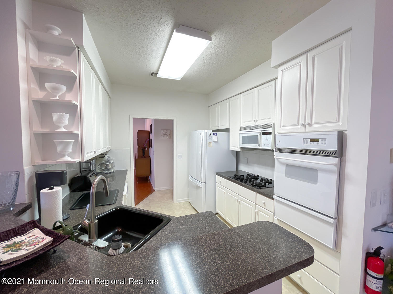 26 Symphony Avenue Bayville, NJ 08721 - Photo 14 of 40 a kitchen with granite countertop a stove and white cabinets