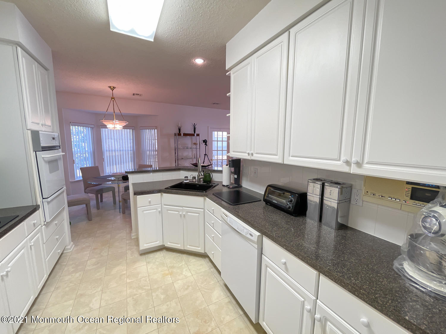 26 Symphony Avenue Bayville, NJ 08721 - Photo 15 of 40 a kitchen with stainless steel appliances granite countertop a sink a stove and a refrigerator