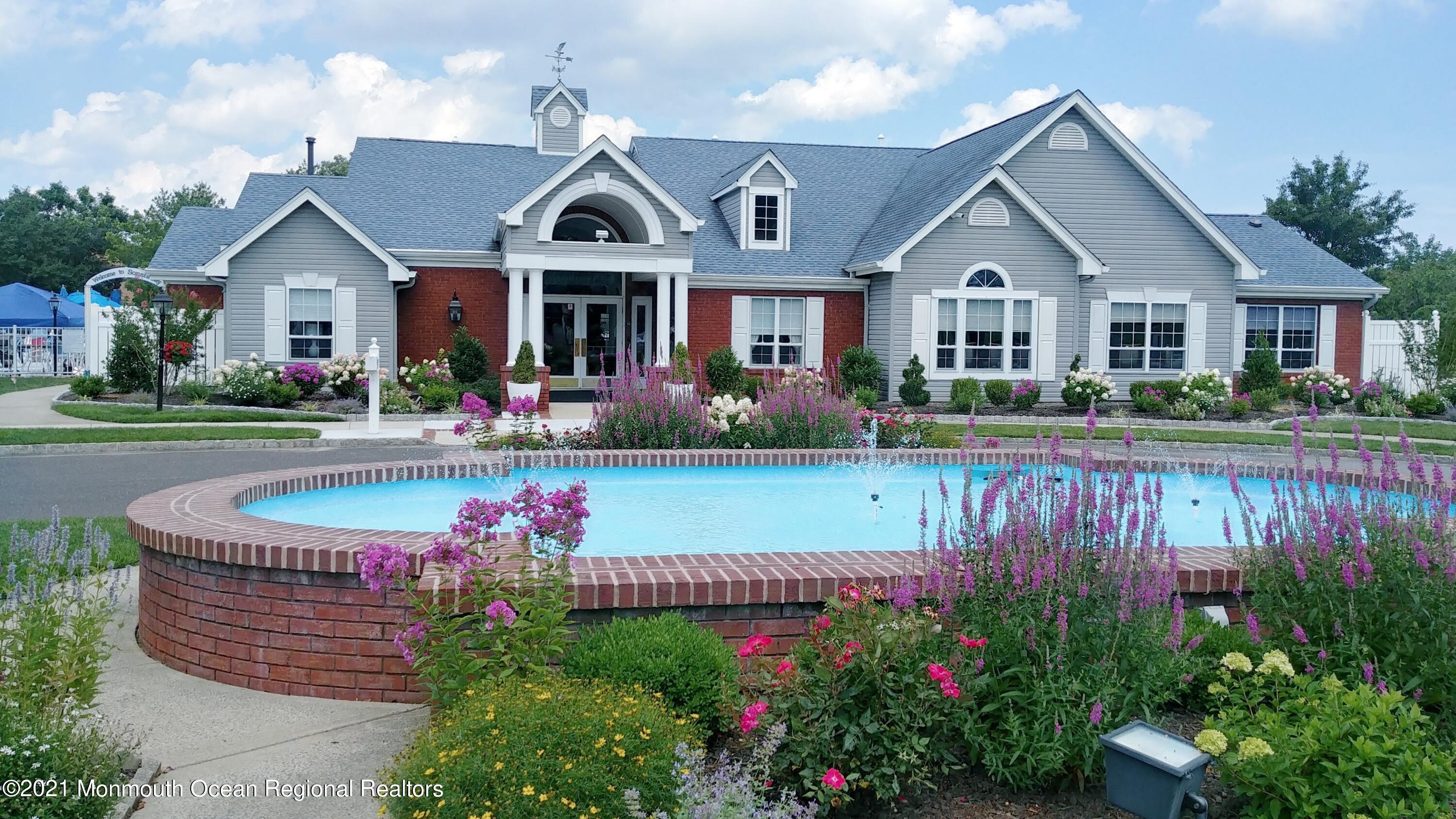 26 Symphony Avenue Bayville, NJ 08721 - Photo 33 of 40 a front view of a house with a yard and potted plants