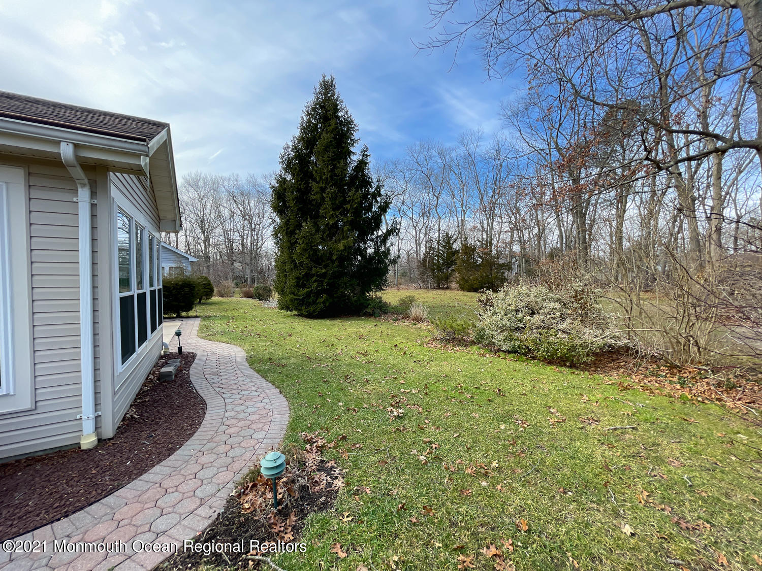 26 Symphony Avenue Bayville, NJ 08721 - Photo 5 of 40 a view of a yard with plants and large trees