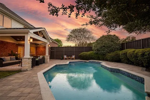 a view of a house with swimming pool and sitting area