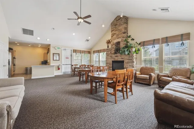 a living room with furniture a fireplace and a chandelier