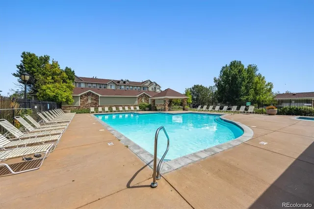a view of a swimming pool with a lounge chair