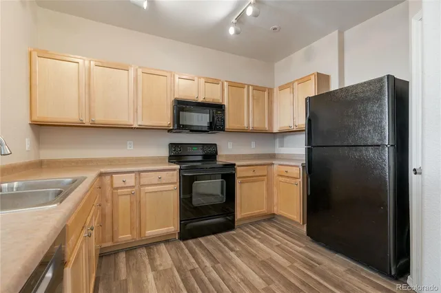 a kitchen with a refrigerator stove and sink