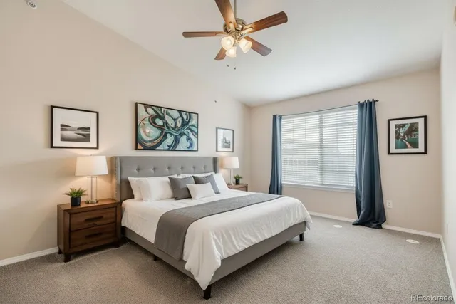 a bedroom with a bed chandelier and window