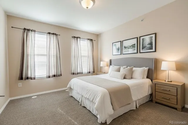 a bedroom with a bed and a large window