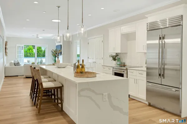 a kitchen with kitchen island a table and chairs in it