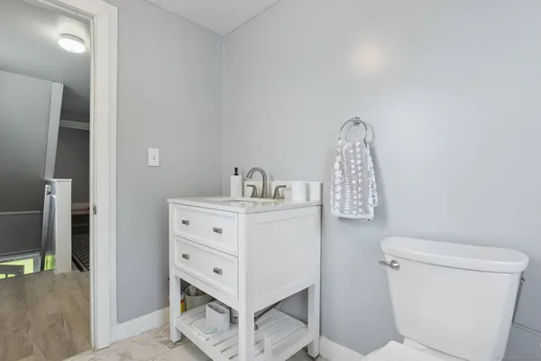 a bathroom with a sink a toilet and vanity