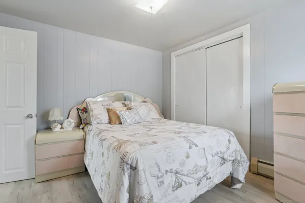 a bedroom with a bed and a closet