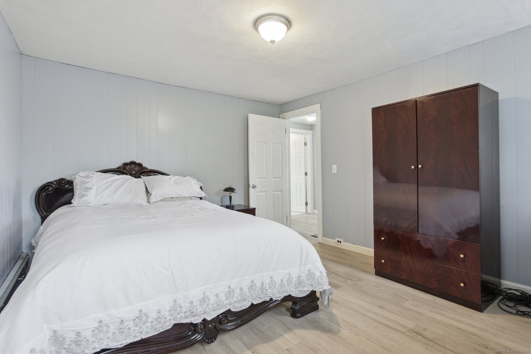 8 3rd Street Norwich, CT 06360 - Photo 16 of 39 a bedroom with a bed and a glass door shower