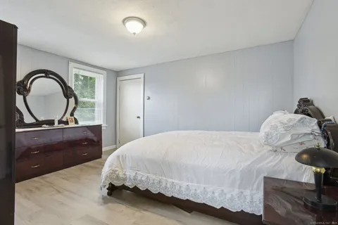 a bedroom with a bed and a dresser