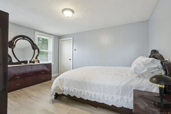 a bedroom with a bed and a dresser