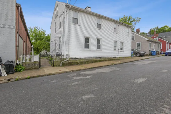 a view of a white house with a street