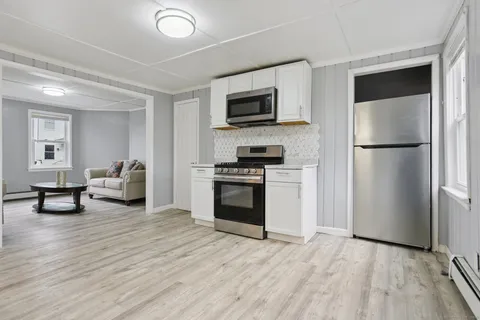 a kitchen with stainless steel appliances a refrigerator stove and microwave