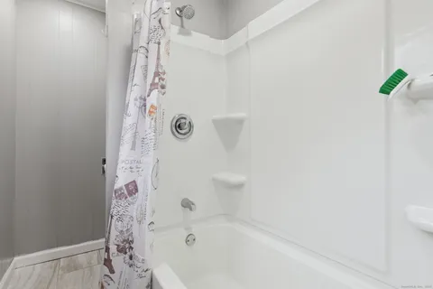 a bathroom with a bathtub and shower