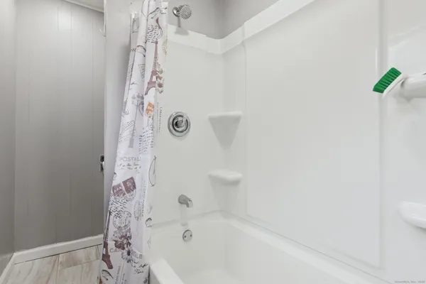 a bathroom with a bathtub and shower