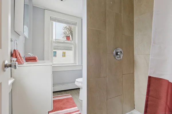 a bathroom with a toilet and a shower curtain