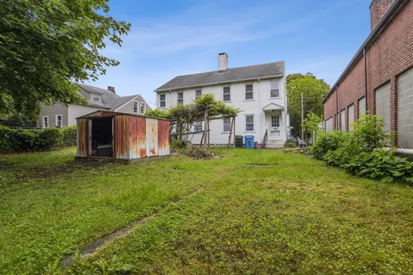 a front view of a house with a garden and yard