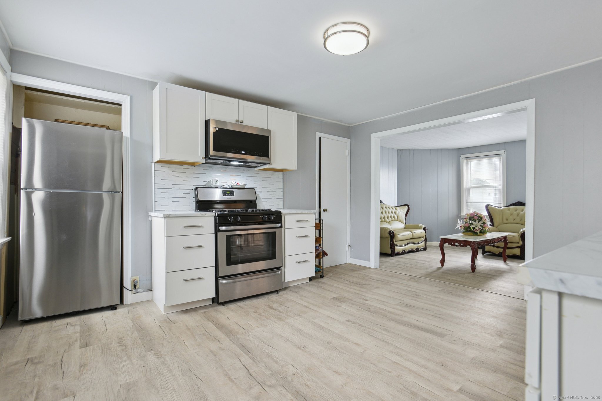 8 3rd Street Norwich, CT 06360 - Photo 4 of 39 a kitchen with a refrigerator stove and microwave