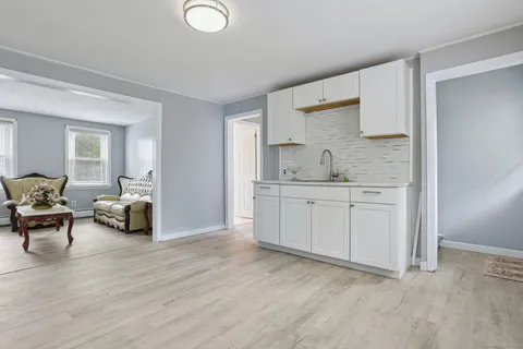 a kitchen with sink and cabinets