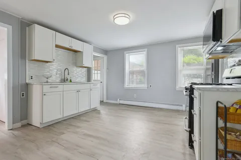 a kitchen with a sink cabinets and window