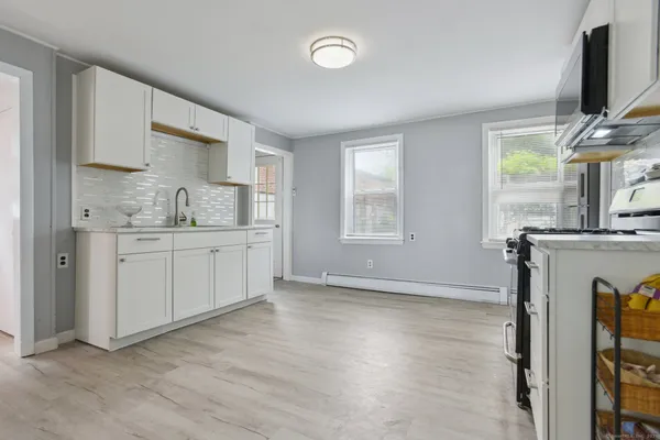 a kitchen with a sink cabinets and window