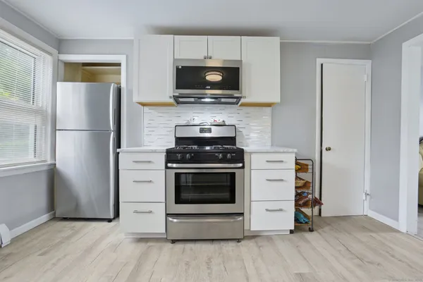 a kitchen with a stove microwave and refrigerator