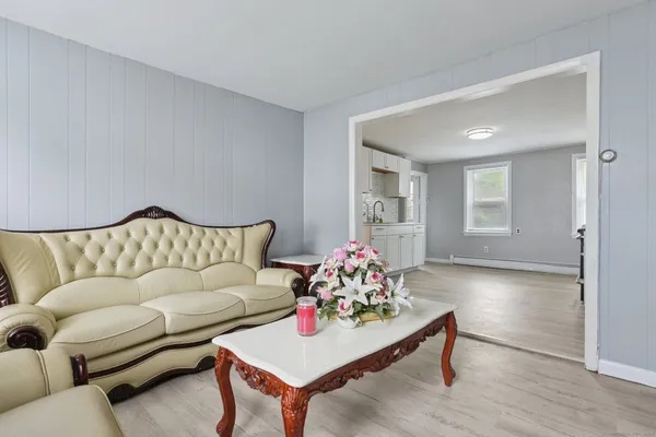 a living room with furniture and wooden floor
