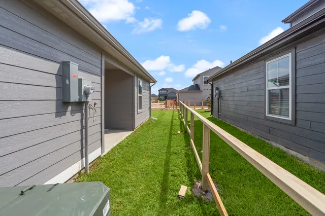 a car parked in front of a house with a yard