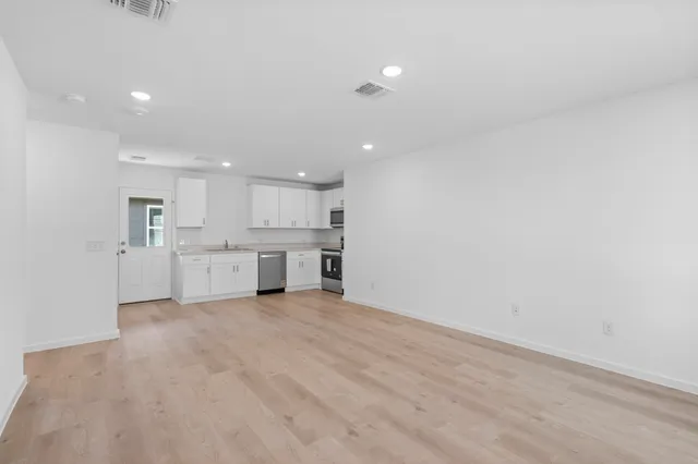a kitchen with appliances cabinets and a sink