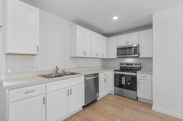 a stove top oven sitting inside of a kitchen